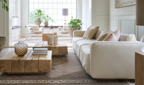 How can adding a rug in an open-plan room help define different areas