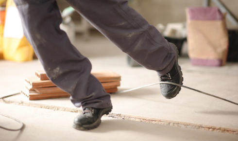 How can checking for slight unevenness underfoot prevent tripping hazards later