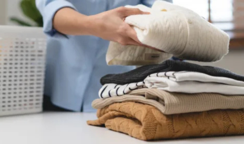 How can choosing darker or patterned fabrics in high-use areas help day-to-day cleaning