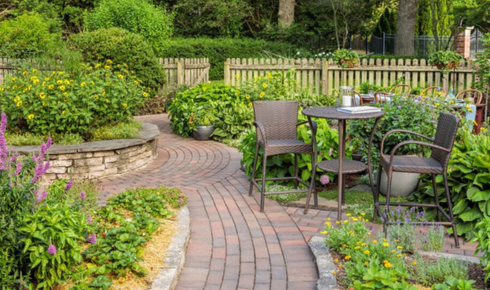 How can creating a small path in a garden make it feel more inviting to explore