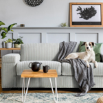 How can repeating one material, like wood or metal, in different rooms make the home feel more unified