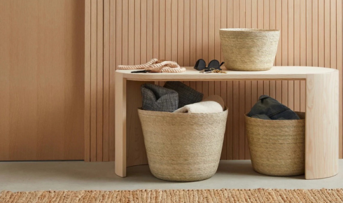 How can using baskets in open shelving keep things looking neat but still easy to reach