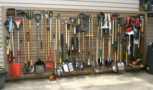 Why is it helpful to group tools in one dedicated corner or storage box outside