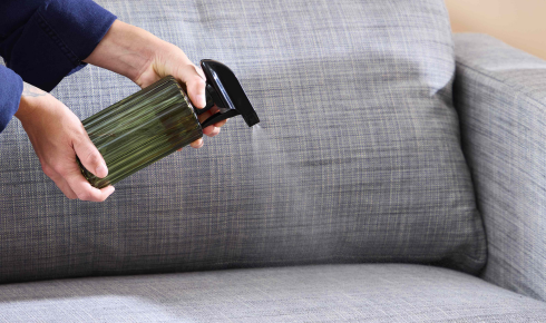 Why is it important to clean under sofas and beds at least a few times a year